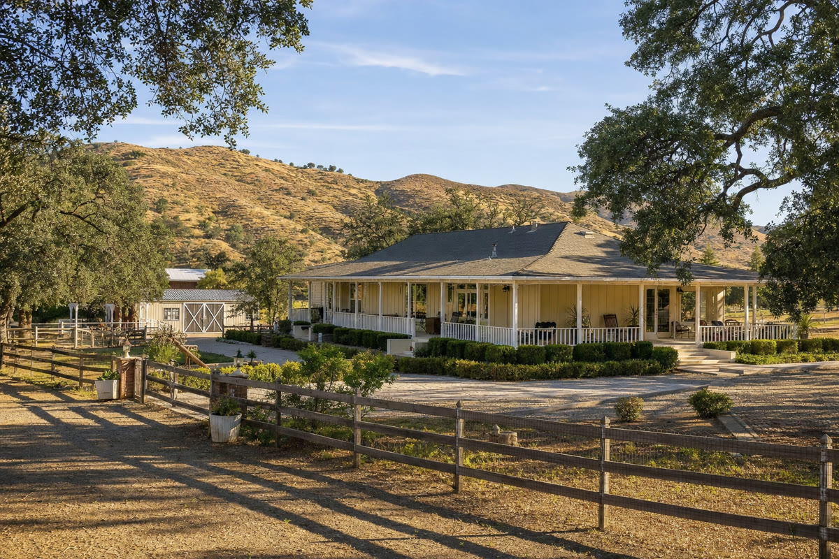 Ranch-style horse property in Chatsworth with wraparound porch and rolling hills