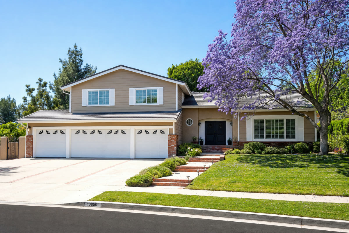 Two-story traditional home in Granada Hills with jacaranda tree in bloom